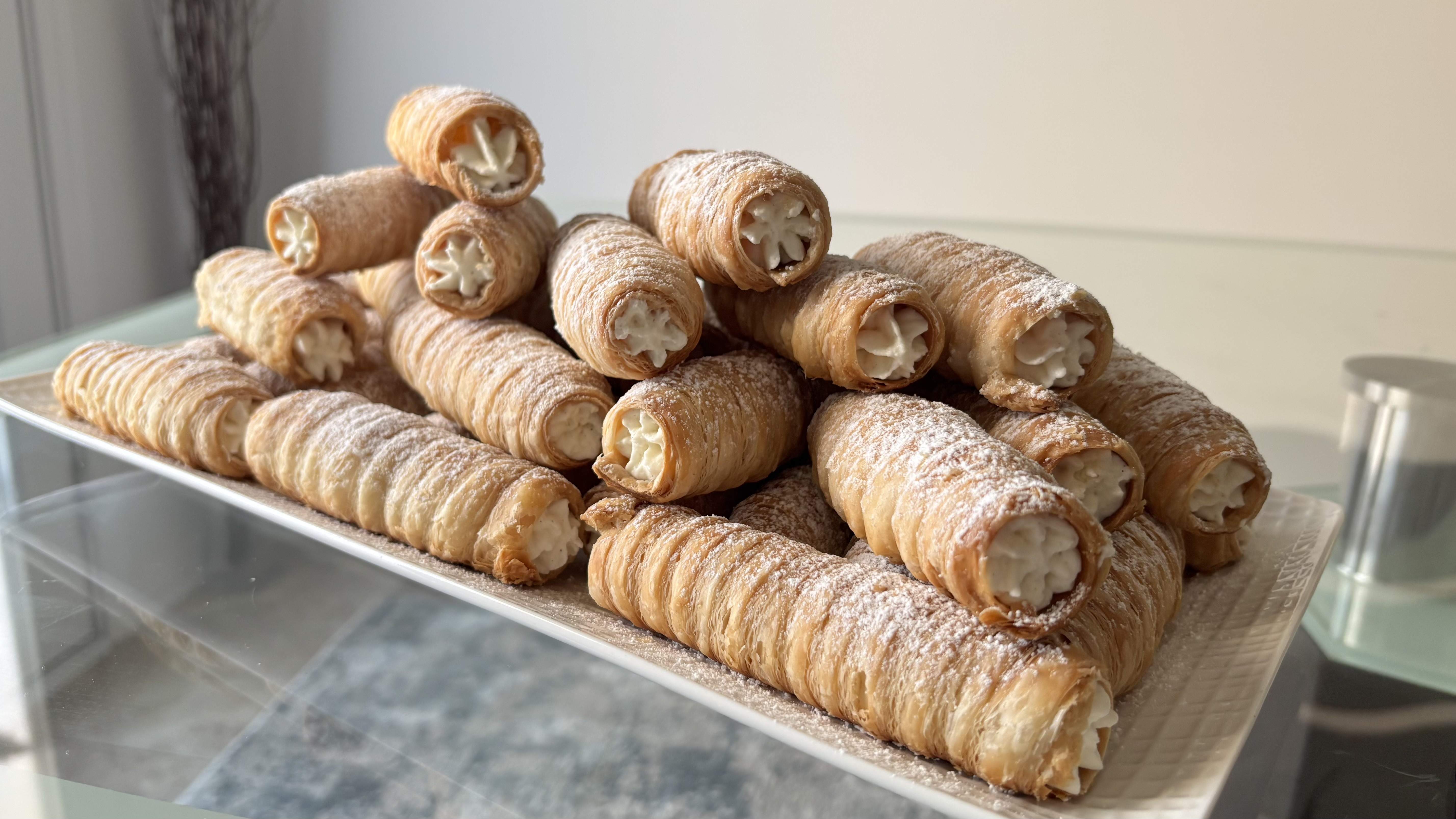 Baker making cream rolls